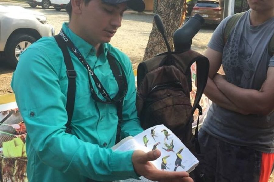 Naturalist guide showing the bird field guide to guests on the Esquipulas tour