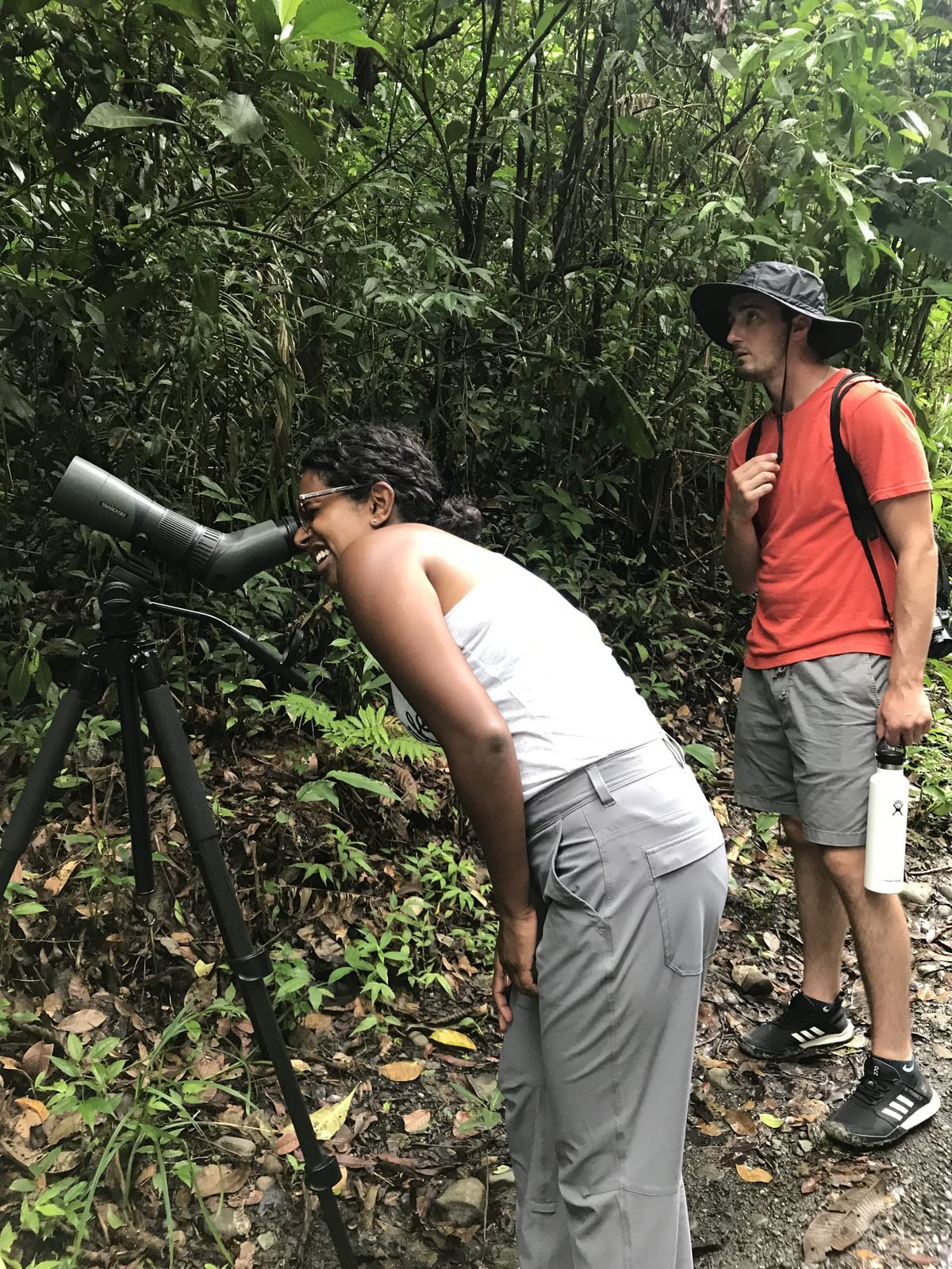 Guests spotting wildlife through a Swarovski scope on the Manuel Antonio guided tour