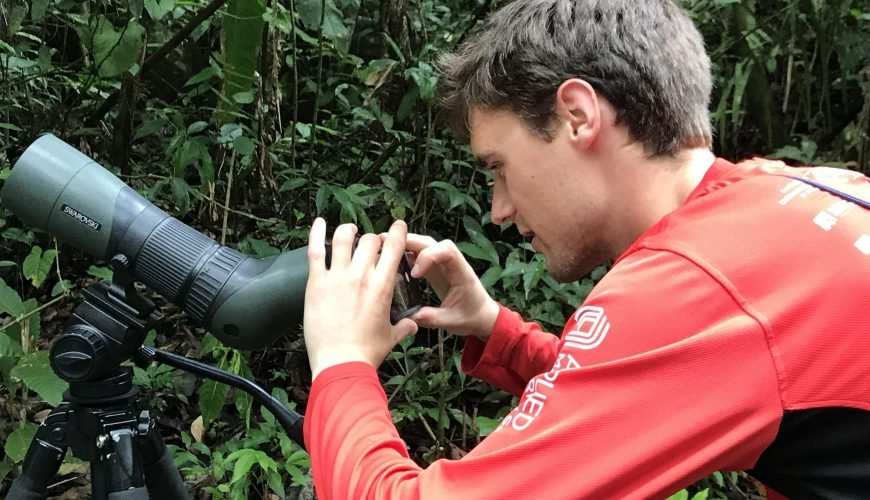 Guest holding a phone to a Swarovski spotting scope to photograph wildlife in the Manuel Antonio rainforest