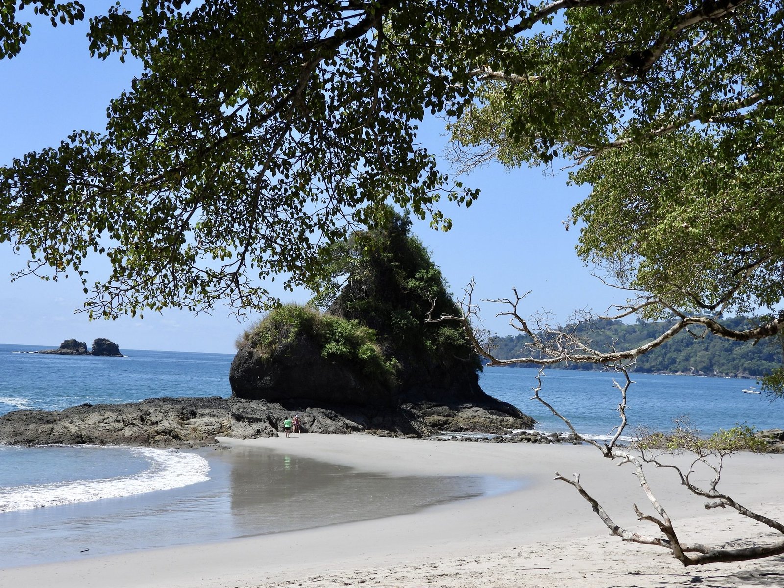 Manuel Antonio National Park beach framed by rock formation and trees