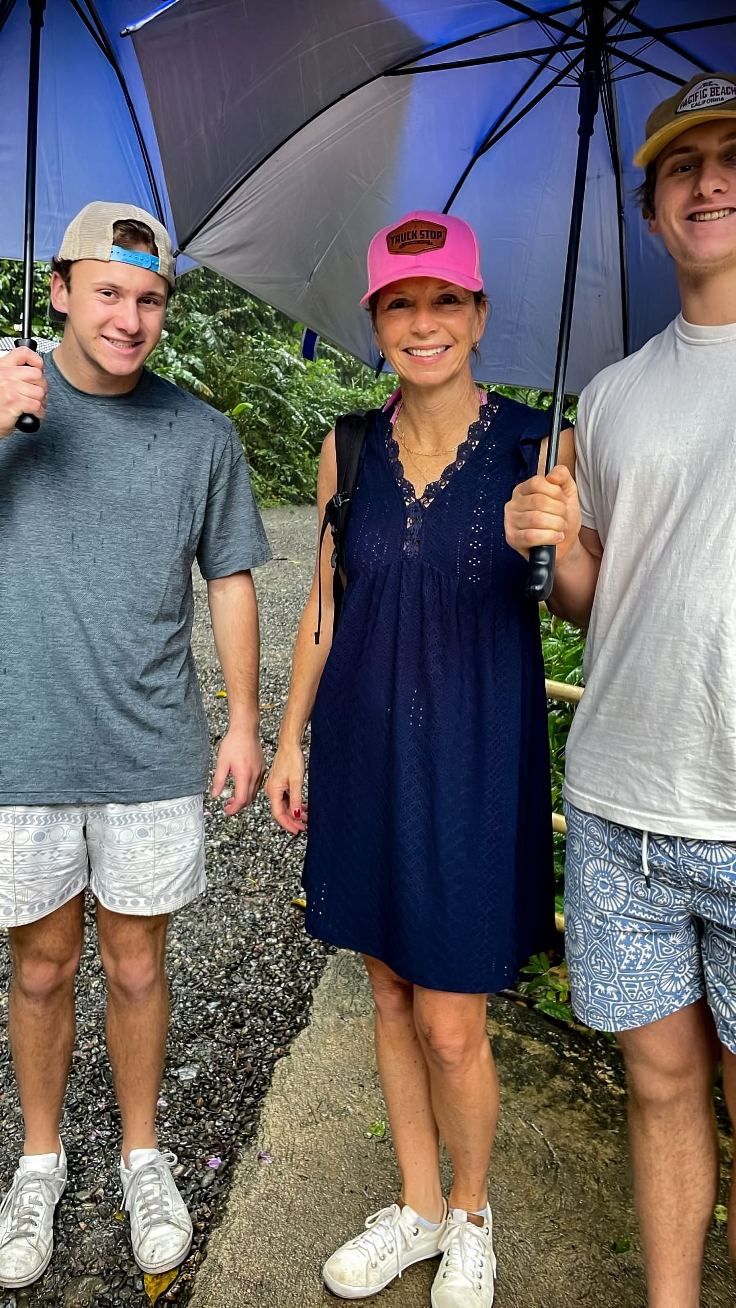 Guests enjoying a rainforest tour under umbrellas